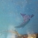 A floor mosaic featuring a stingray swimming alongside some coral reefs